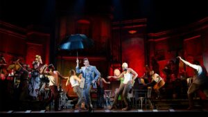 Wide shot of the casts of Hadestown on stage dancing on Broadway in NYC, New York, USA