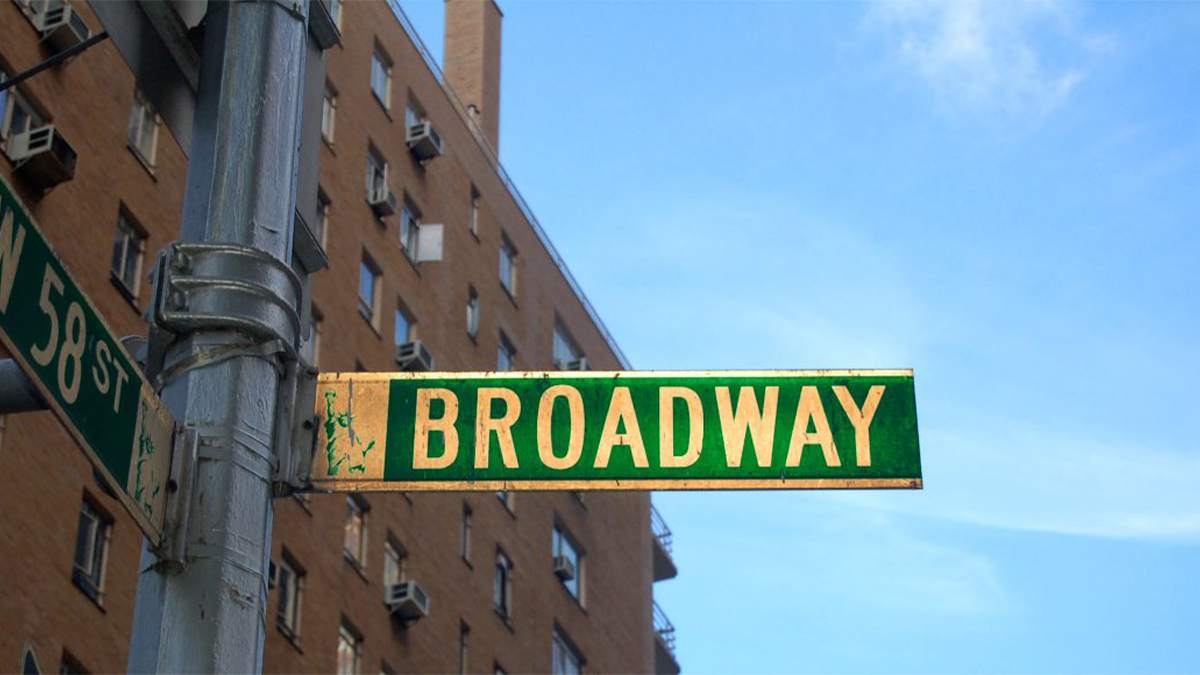Close up of Broadway Street Sign with Building behind - NYC, New York, USA