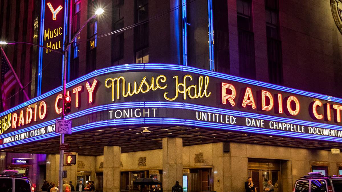 Wide shot of the large wrap around neon sign for the Radio City Music Hall in NYC, New York, USA