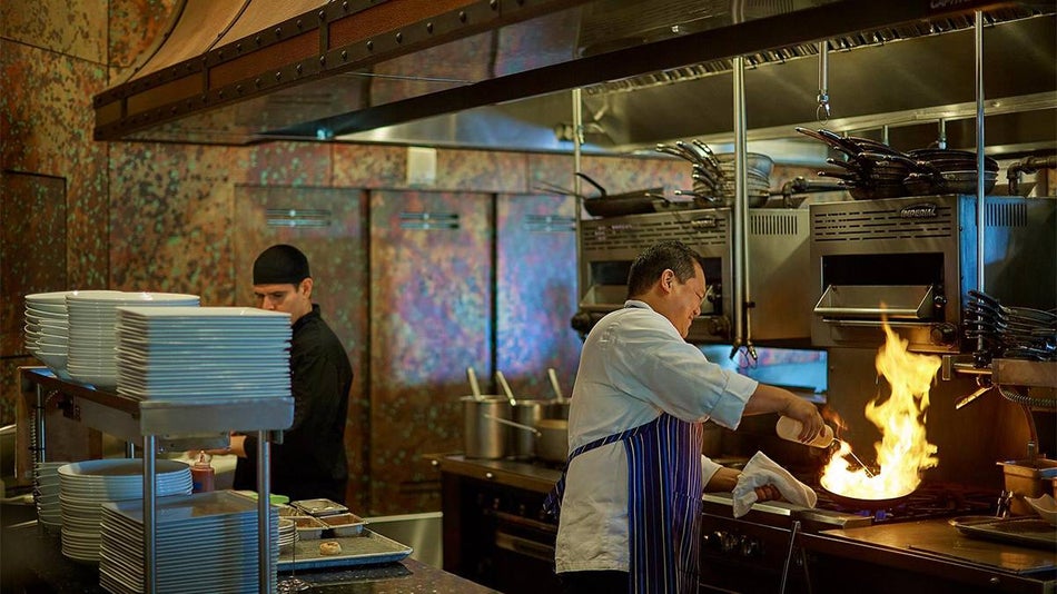 Wide shot of chefs working in the kitchen at Deep Blu Seafood Grille in Orlando, Florida, USA