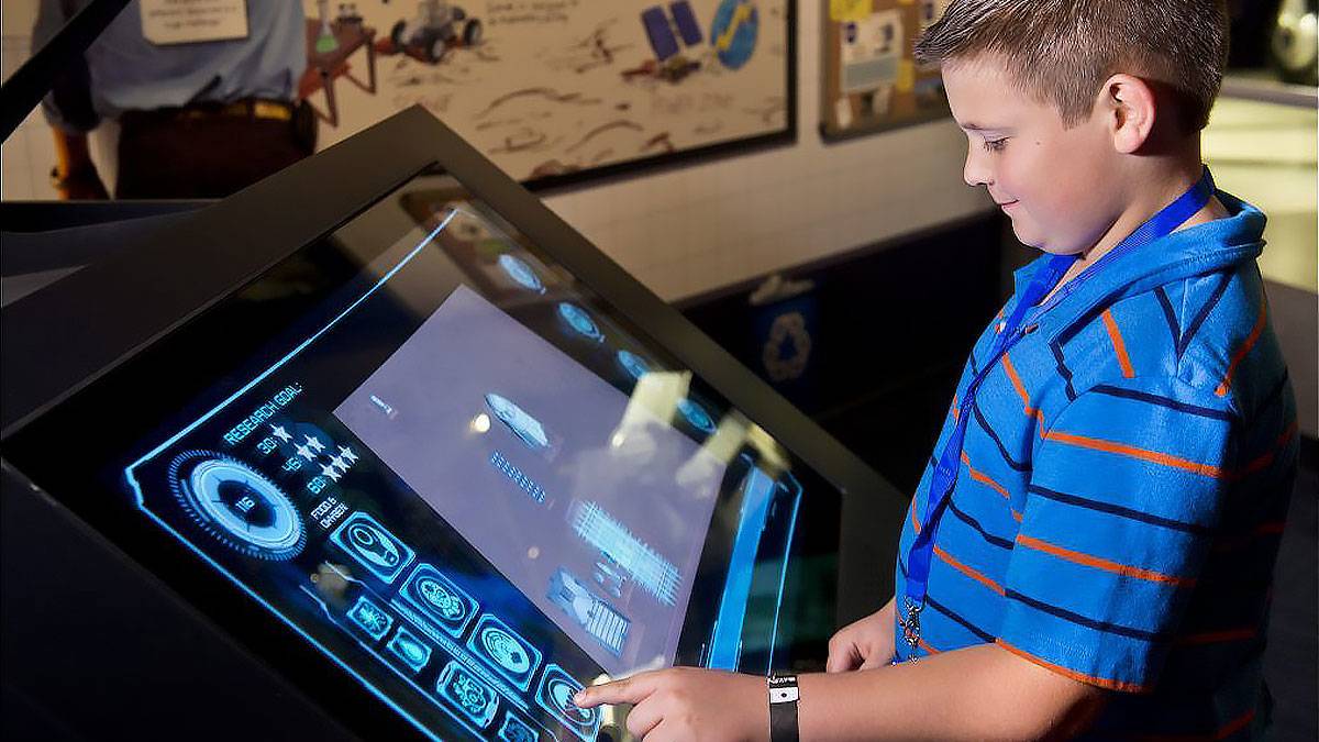 Child Playing Cosmic Quest at Kennedy Space Center - Orlando, Florida, USA
