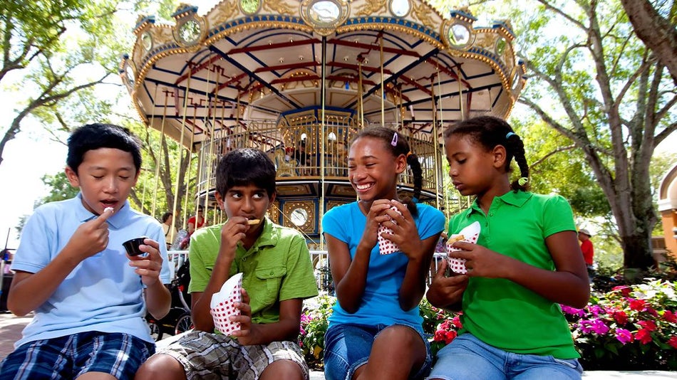 Kids eating food in front of Merry-Go-Round at LEGOLAND in Orlando, Florida, USA