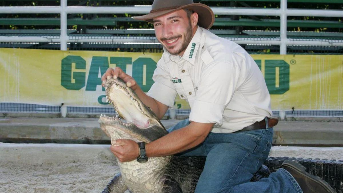 Man Posing with an Alligator at Gatorland - Orlando, Florida, USA