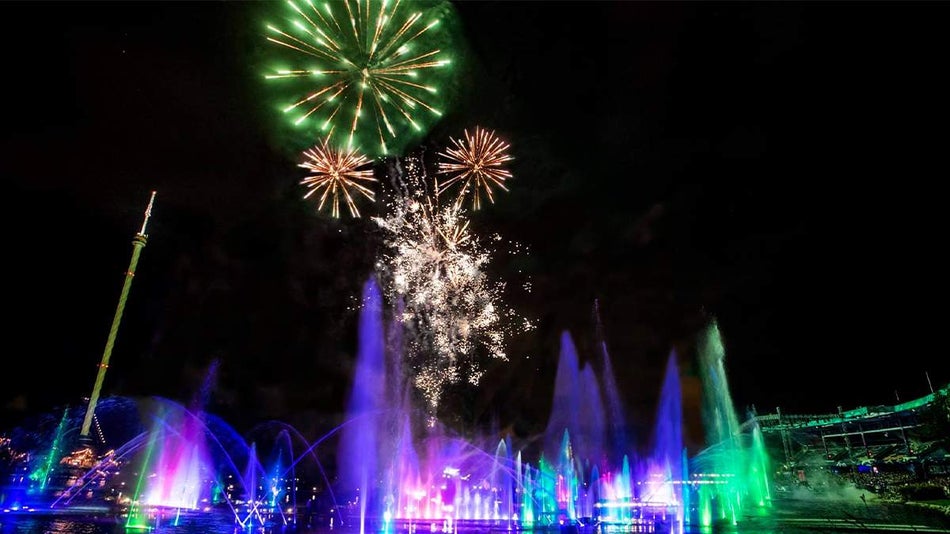 Looking up at bright fireworks and a water show with lights at SeaWorld Orlando in Orlando, Florida, USA
