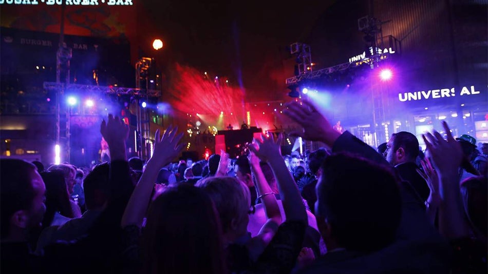 A crowd of people dancing at Universal CityWalk at night on New Years Eve in Orlando, Florida, USA