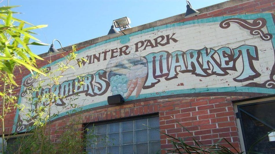 close up of Winter Park Farmer's Market sign on brick building in Orlando, Florida, USA