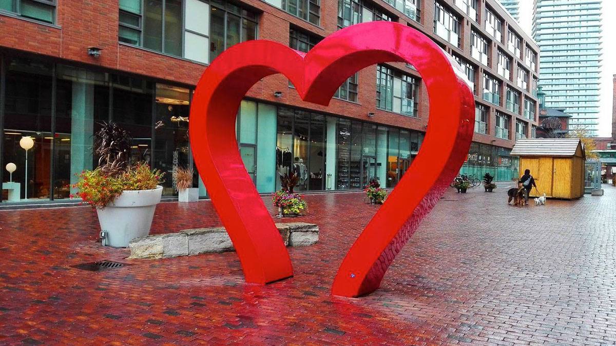 Close up of Distillery District Heart Sculpture on the wet pavement in Toronto, Ontario, Canada