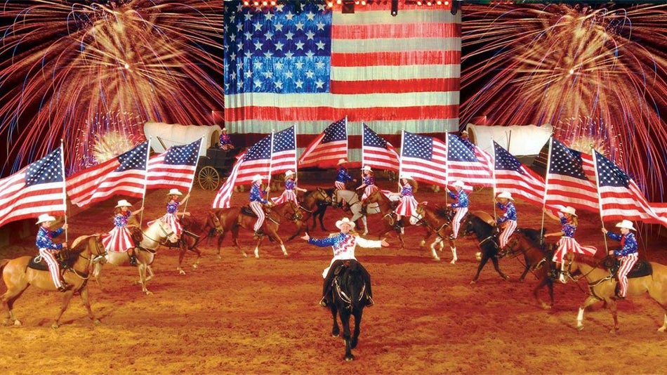 horses and Usa flags at Dolly Parton Dixie Stampede Flag Finale With Fireworks
