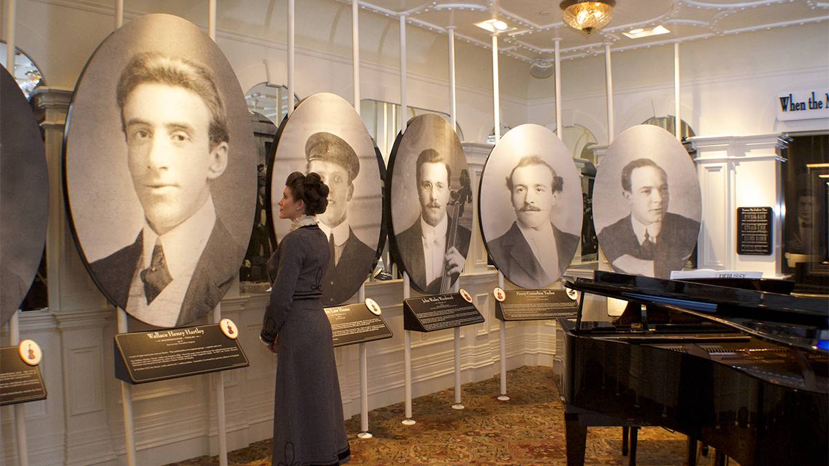 Portraits of the musicians that were on the Titanic on the left and a grand piano on the right at the Titanic Museum in Pigeon Forge, Tennessee, USA