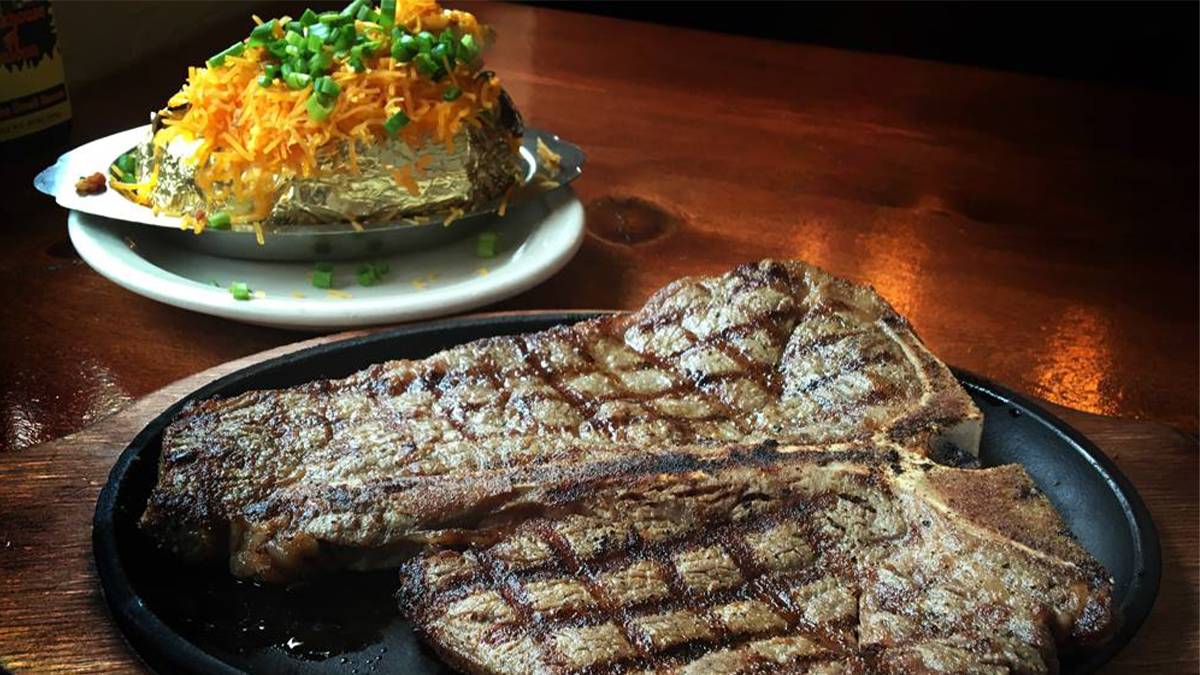 close up of steak and baked potato at Alamo Steakhouse in Pigeon Forge, Tennessee, USA