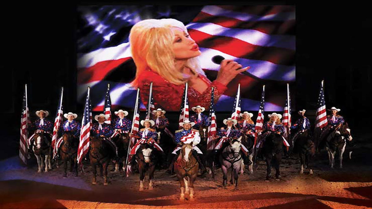 people on horses holding american flags at Dolly Parton's Stampede in Pigeon Forge Tennessee USA