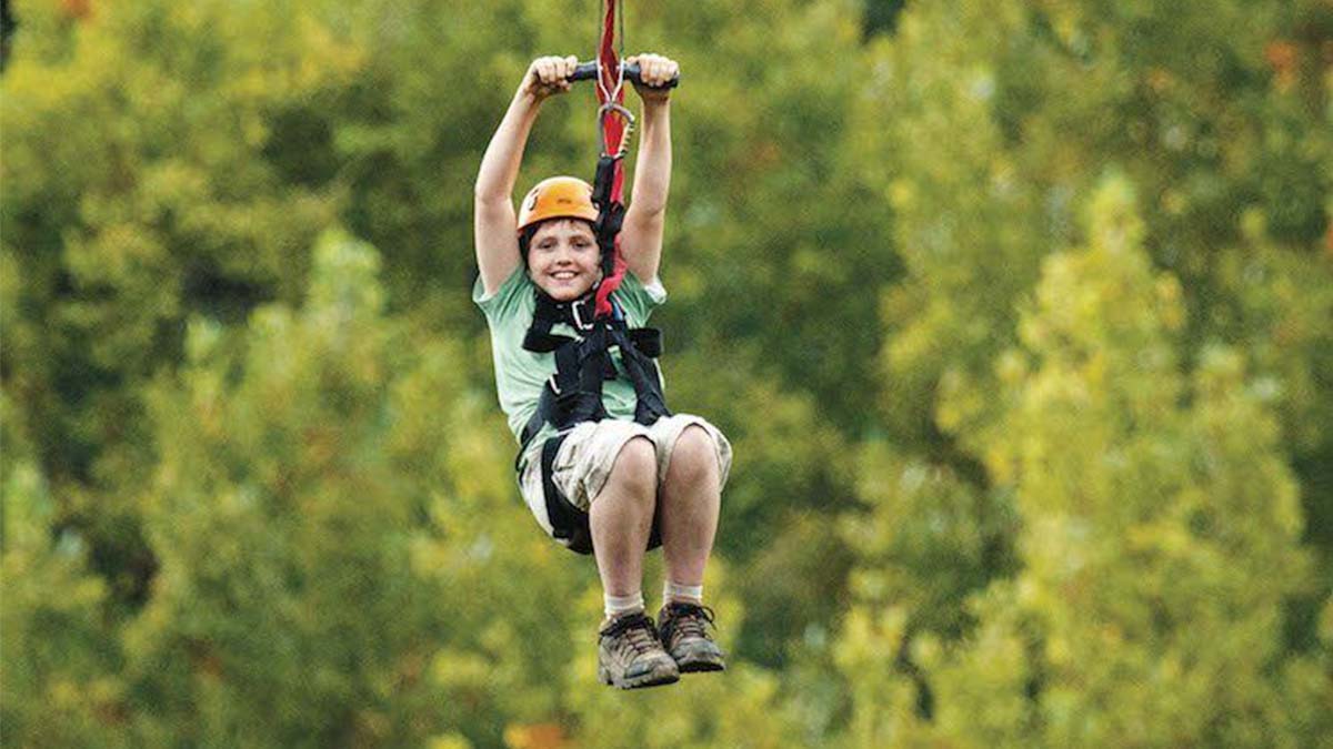 boy on zipline at Foxfire Mountain Adventure Park in Pigeon Forge, Tennessee, USA