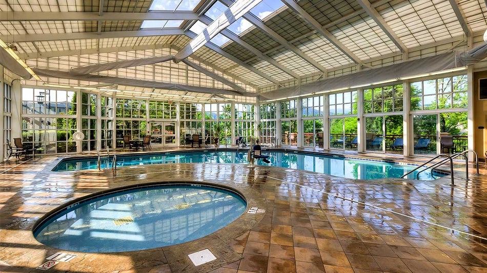 Indoor pool at Riverstone Resort & Spa with hot tub and windows in Pigeon Forge, Tennessee, USA