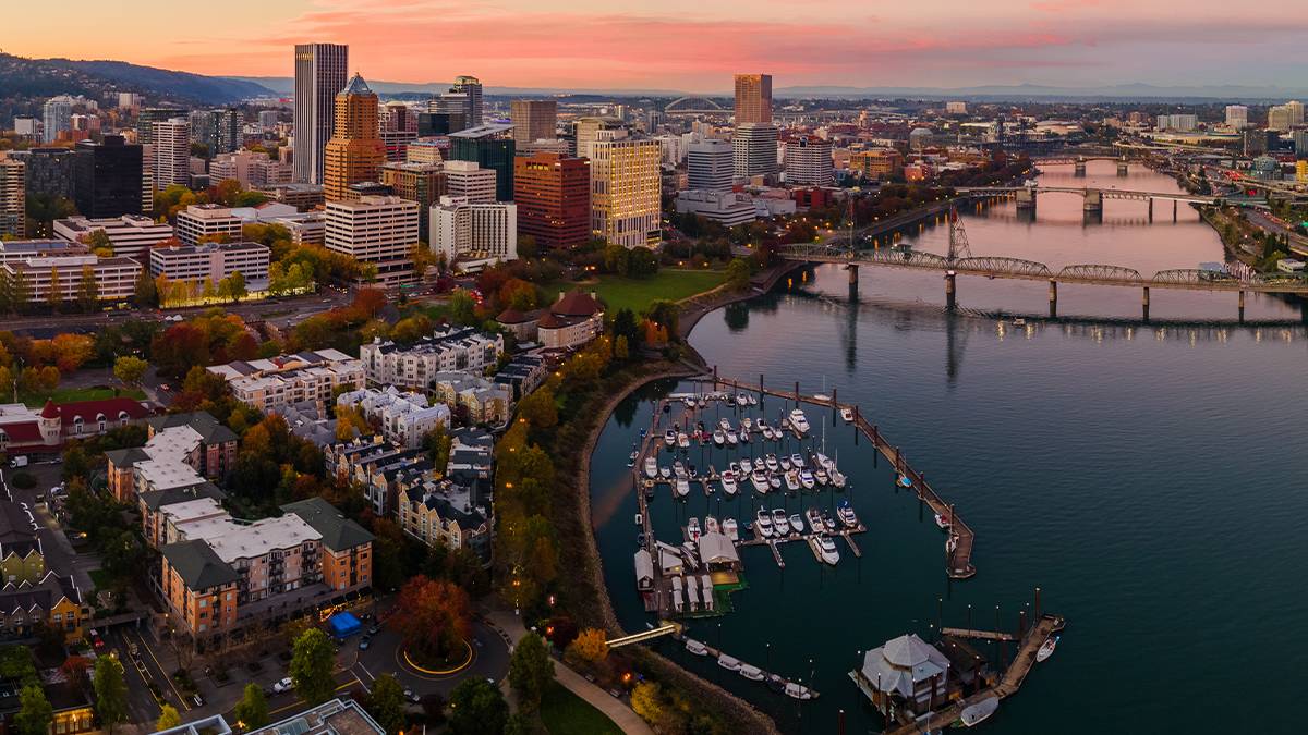 Aerial view of downtown Portland with a pink sunset and fall trees in Portland, Oregon, USA