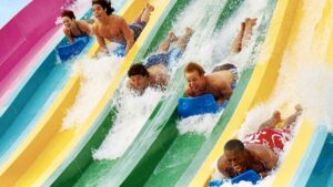 People sliding down colorful slides on the Taumata Race Aquatica in San Antonio, Texas, USA