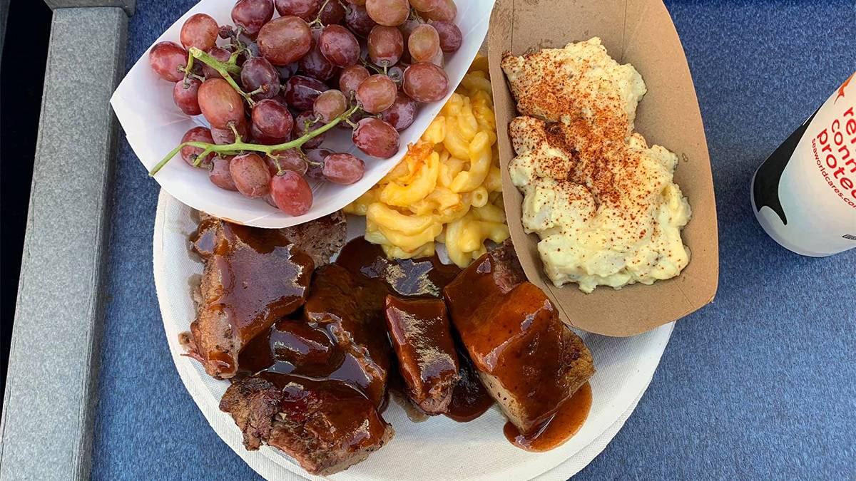 Close up of a plate of barbecue with Mac and cheese, potato salad , and grape from Calypso Bay Smokehouse at SeaWorld in San Diego, California, USA