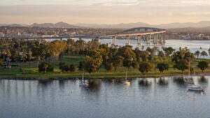 Aerial view looking over Coronado Island and the bridge that leads to the mainland at dusk near San Diego, California, USA