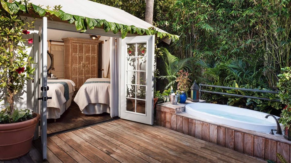View of the bath rum and massage room with two beds and lots of greenery surrounding it at The Spa at Estancia La Jolla in San Diego, California, USA