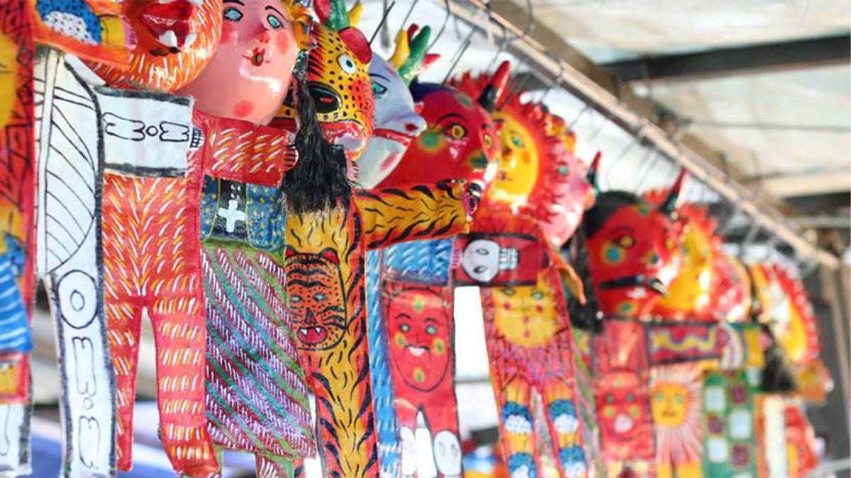 Close up of brightly colored masks, mostly red, of different animals and faces on the Tijuana Up & Down City Tour near San Diego, California, USA