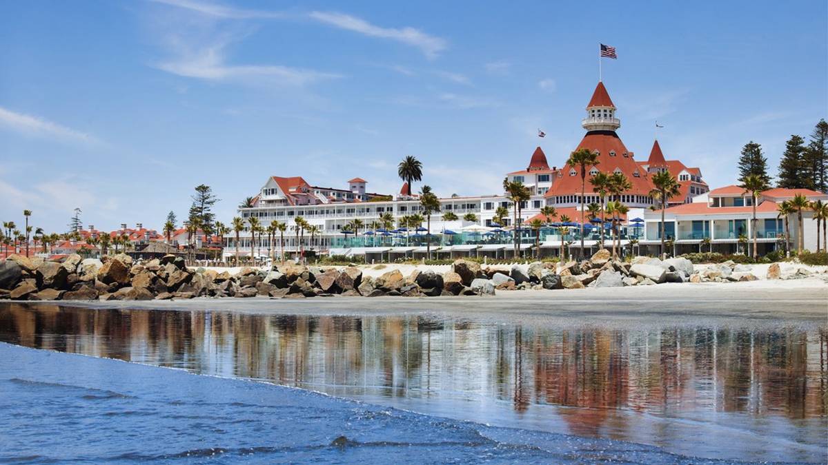 Exterior ground view of Hotel del Coronado along sandy beach in San Diego, California, USA