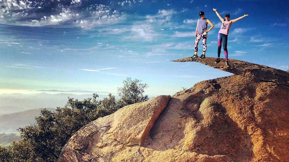 couple standing on potato chip rock on a sunny day in San Diego, California, USA