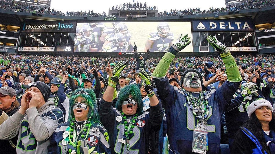 Wide shot of people in Seattle Seahawks jerseys and spirit gear at a game in Seattle, Washington, USA