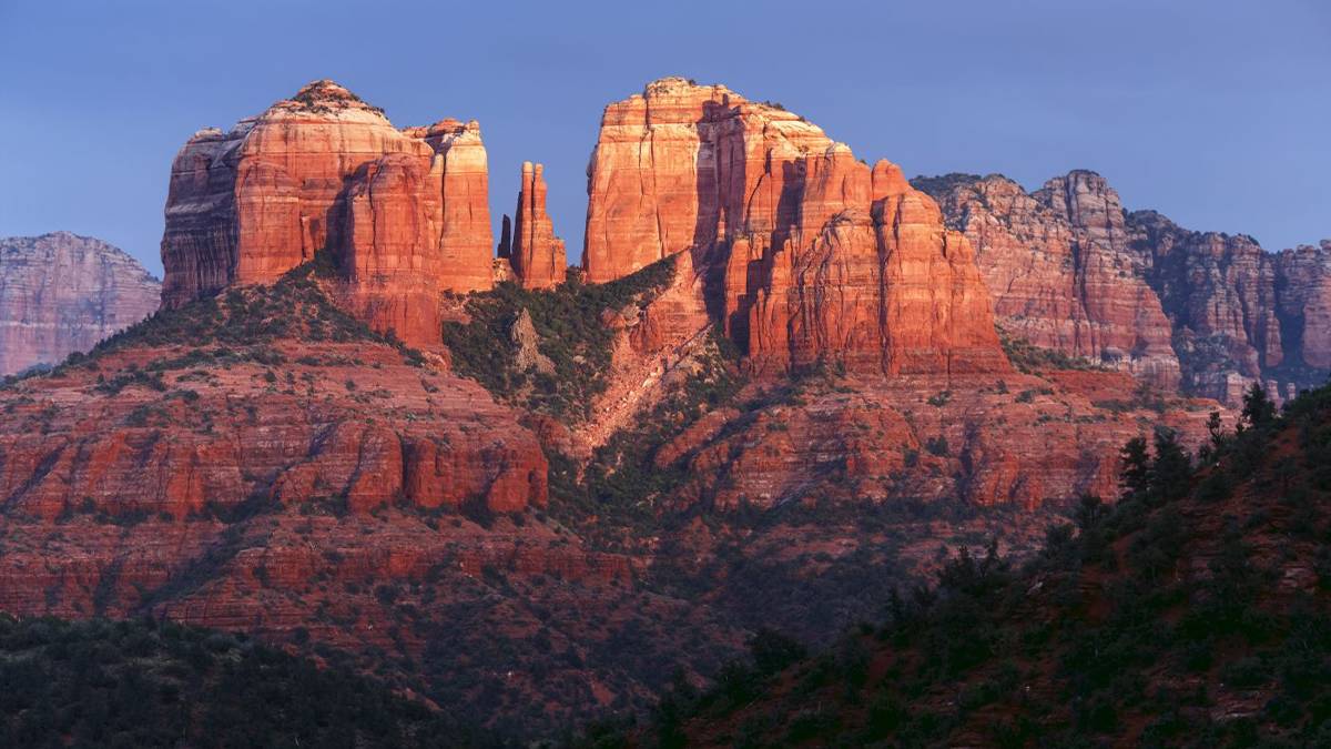 Wide shot of Cathedral Rock at sunset with the sun shining on it in Sedona, Arizona, USA