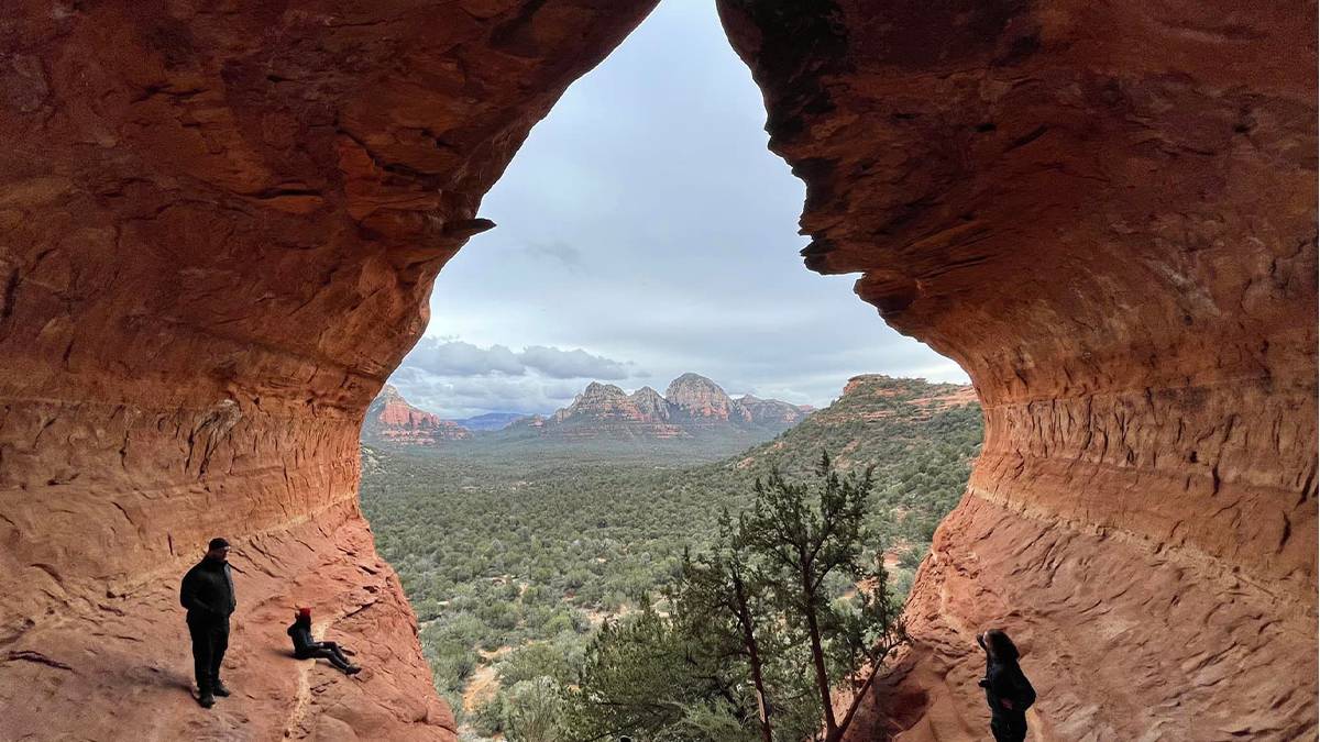 View out of the Sedona Birthing Cave looking at the mountains and trees in Sedona, Arizona, USA