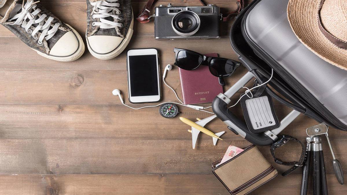 suitcase with passport wallet phone and shoes