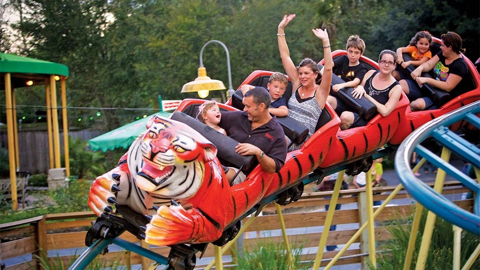 Close up of people riding the Tasmanian Tiger Coaster and having fun at ZooTampa in Tampa, Florida, USA