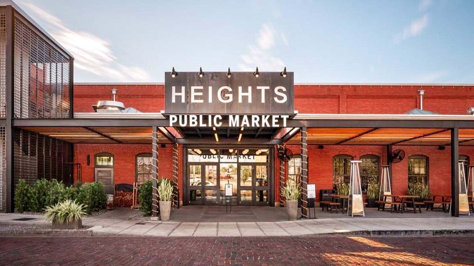 View of the front of Armature Works and a giant sign that says HEIGHTS PUBLIC MARKET on a brick building in Tampa, Florida, USA