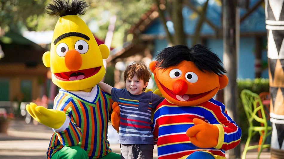 Close up photo of Bert and Ernie from Sesame Street posing with a young boy at Busch Gardens Tampa in Tampa, Florida, USA