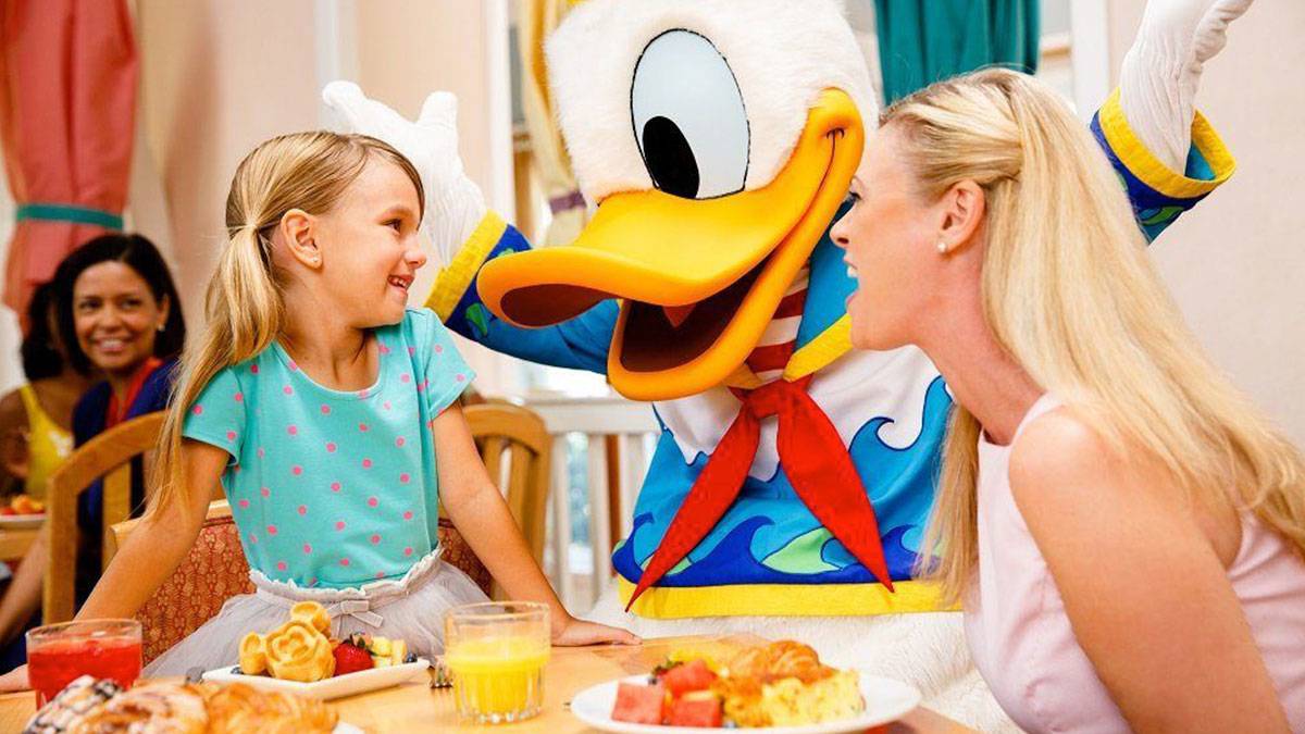 Mom and Daughter with Daffy Duck at a Breakfast with Disney Character Dining at Walt Disney World - Orlando, Florida, USA