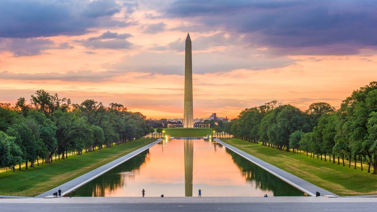 sunset behind the Washington Monument and reflecting pool in Washington D.C., USA