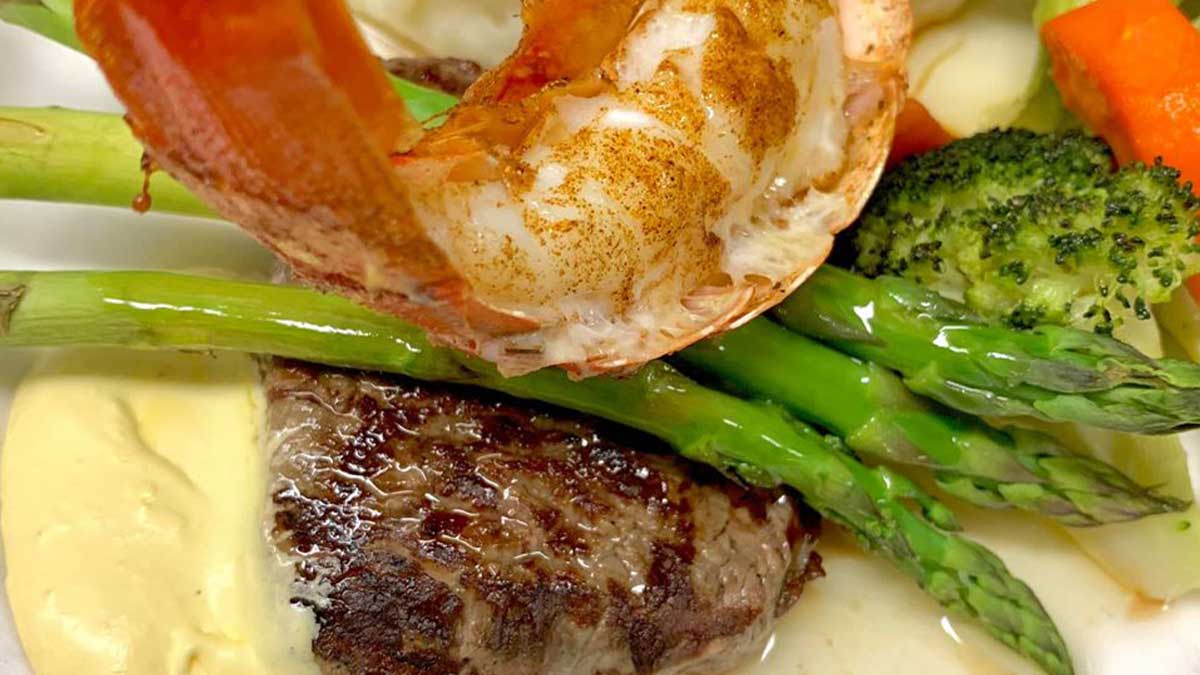 Close up photo of a surf and turf dinner with asparagus and other veggies from Seafare of Williamsburg in Williamsburg, Virginia, USA