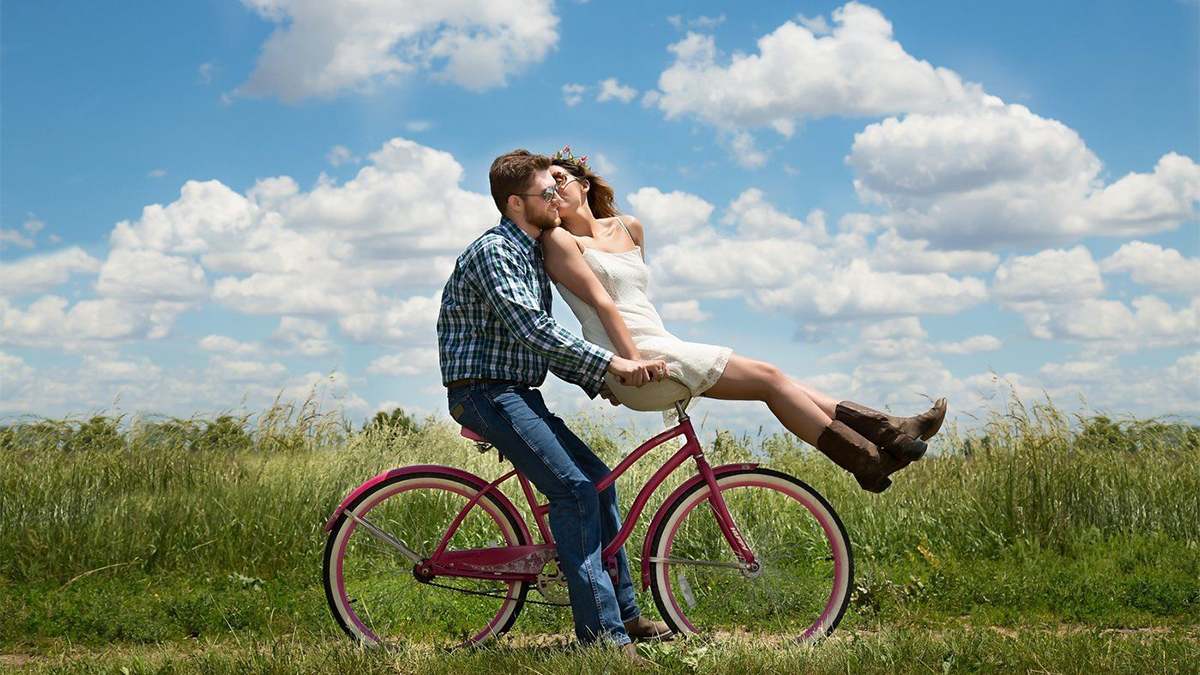 couple on bike together in field