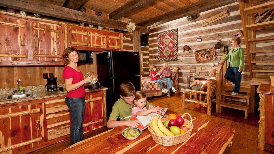 Wide shot of a family relaxing at the Wilderness Resort at Silver Dollar City, a room almost made entirely out of carved wood in Branson, Missouri, USA
