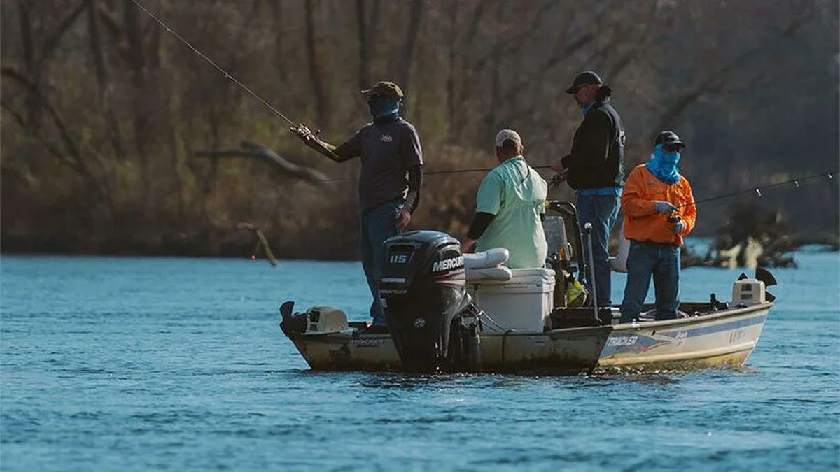 two men on a boat fishing in Lake Taneycomo in Branson, Missouri, USA