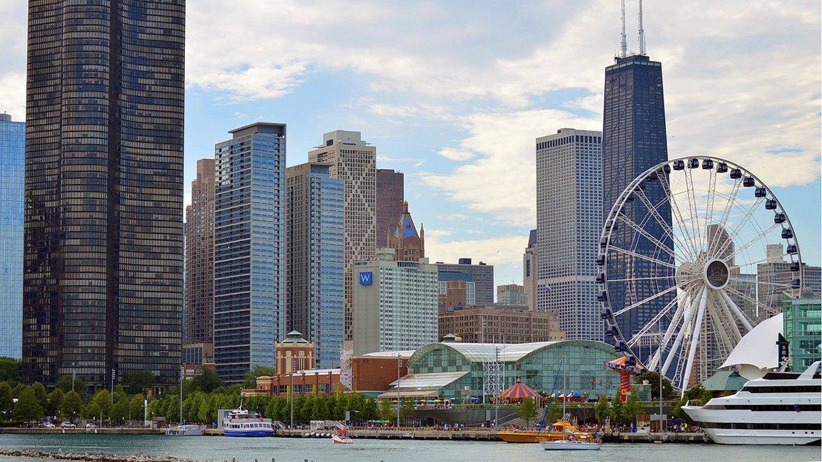 wide view of navy pier with the skyline in the background in Chicago, Illinois, USA