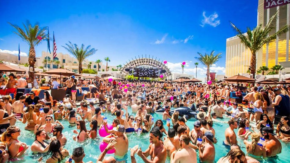 Wide shot of the Daylight Beach Club at Mandalay Bay so full of people you can barely see the water on a sunny day in Las Vegas, Nevada, USA