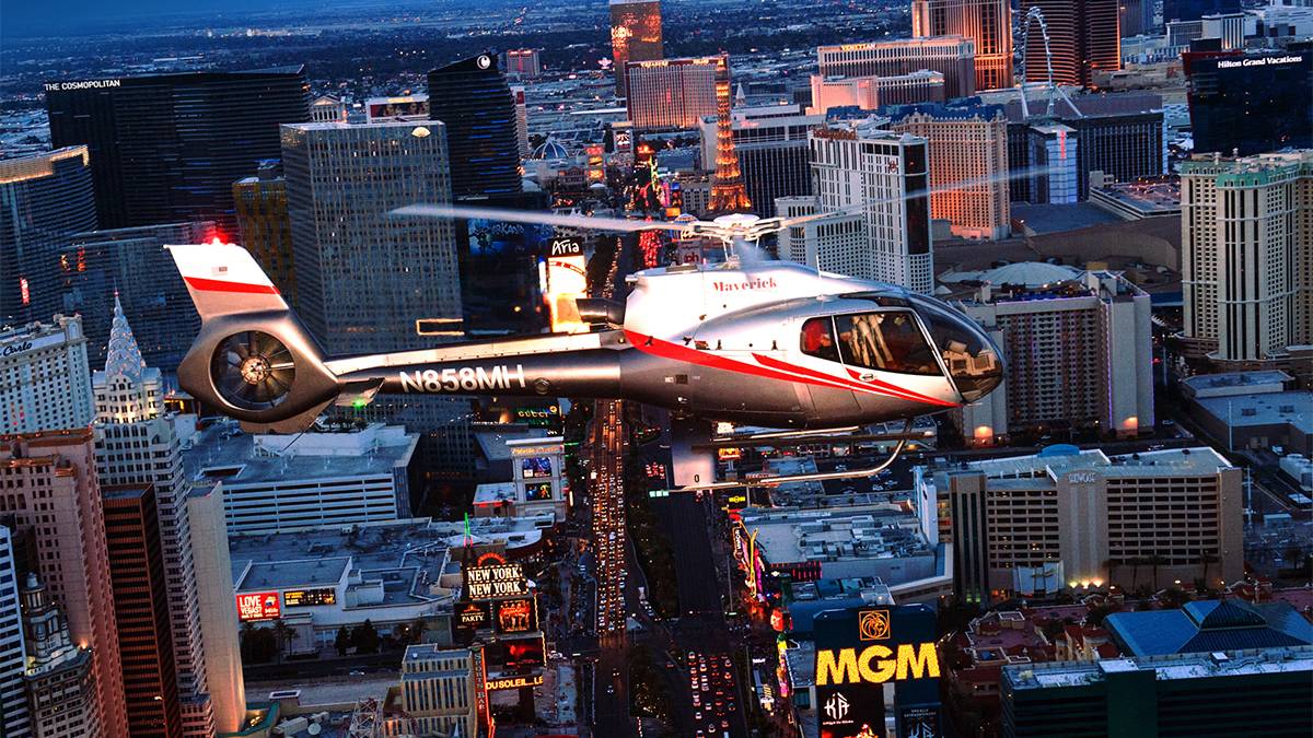 View of a silver red and black helicopter flying over Las Vegas at sunset on the Maverick Las Vegas Helicopter Tours in Las Vegas, Nevada, USA