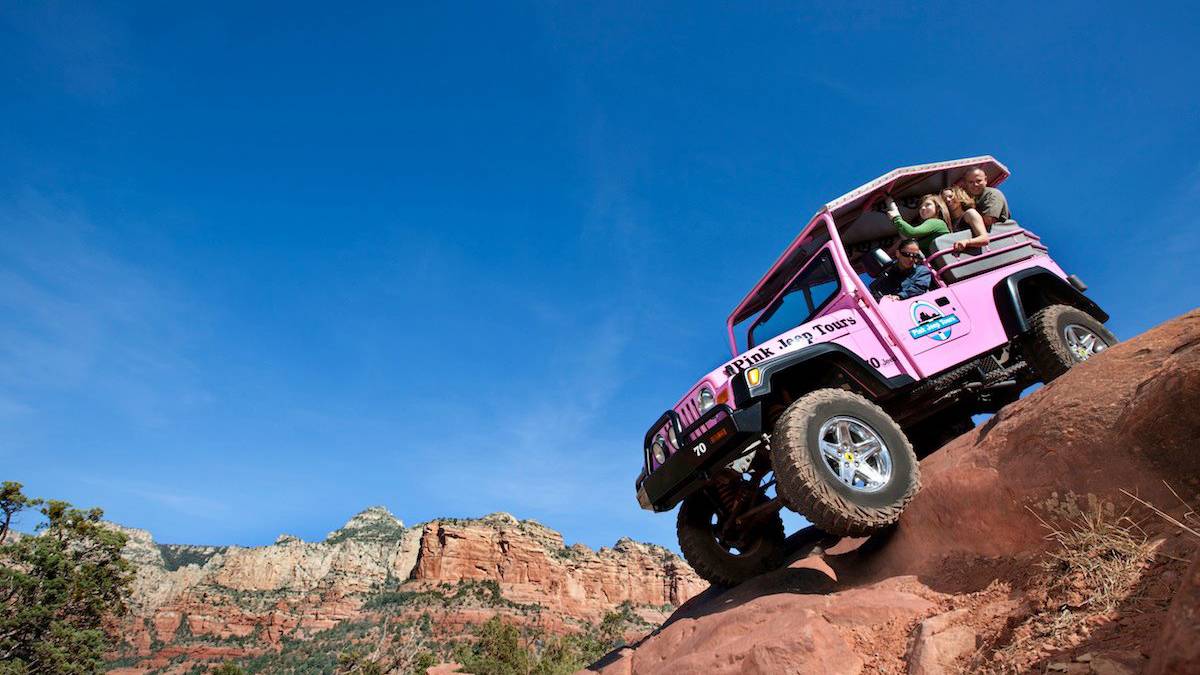 Close up of a family in a Pink Jeep driving down the desert rocks on a Pink Jeep Tour near Las Vegas, Nevada, USA
