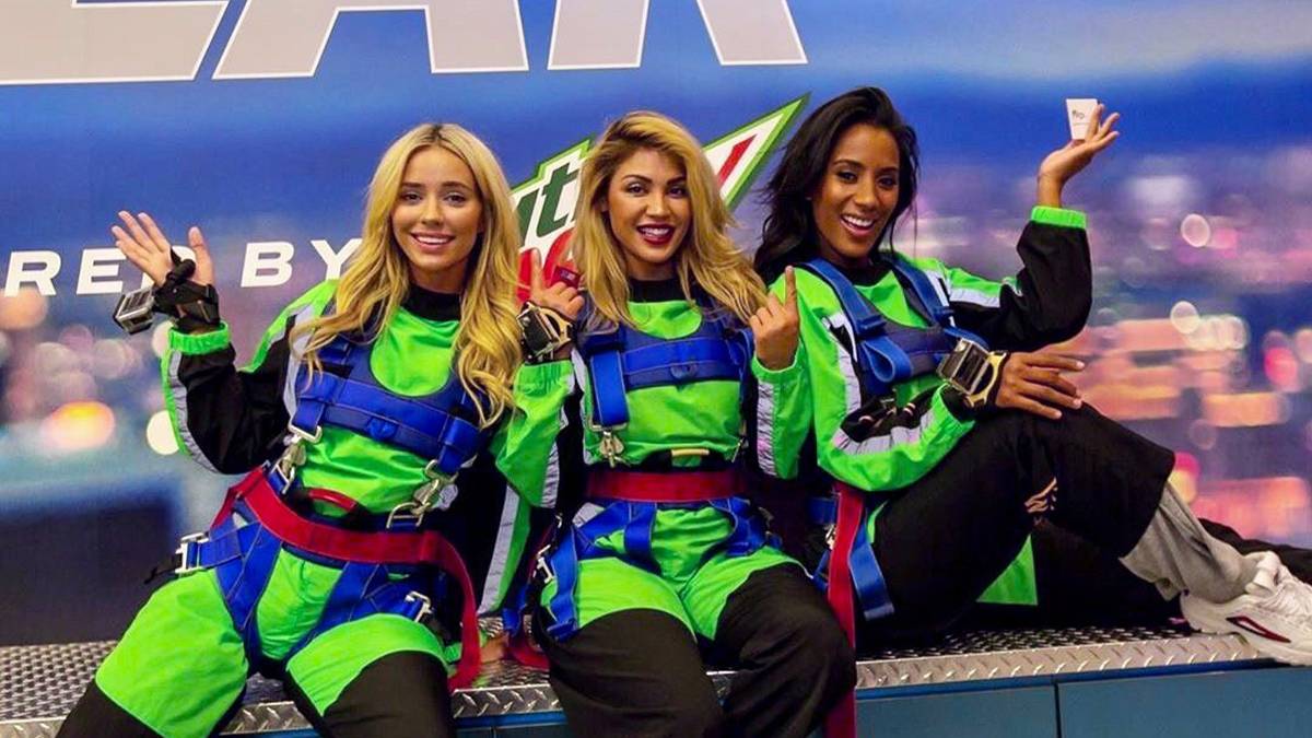 Three women in neon green gear and harnesses ready to jump at the SkyJump at the STRAT in Las Vegas, Nevada, USA