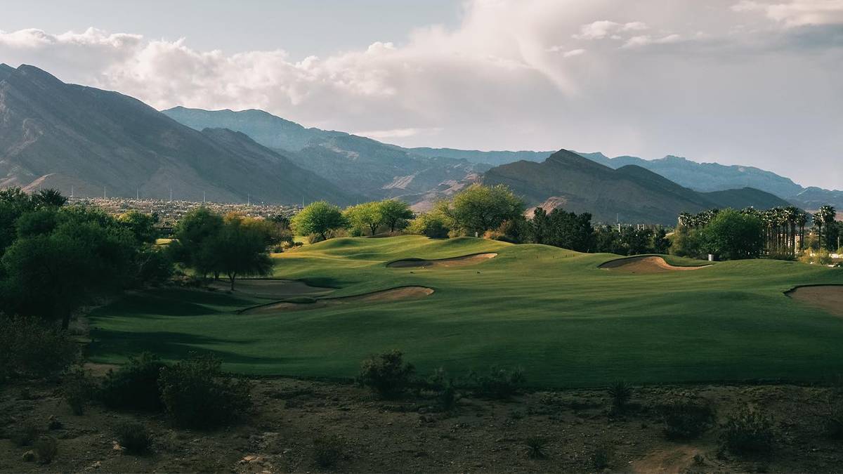 Wide shot of the rolling golf courses at TPC Las Vegas with mountains in the background in Las Vegas, Nevada, USA
