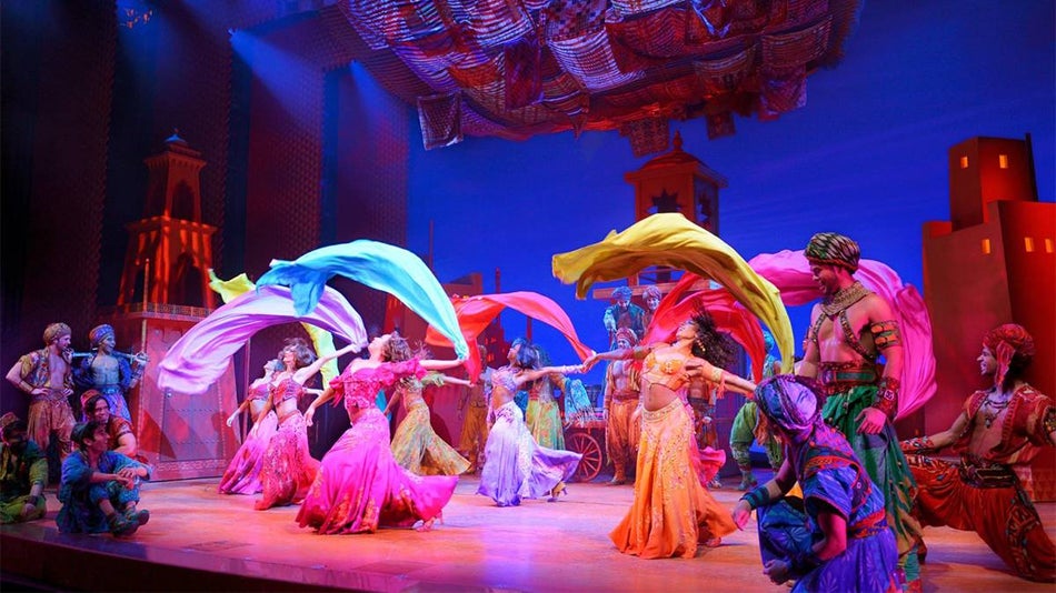 dancers on stage with colorful costumes performing Disney's Aladdin in Los Angeles, California, USA