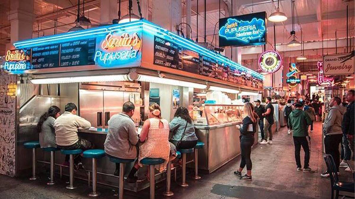 people eating a restaurant bar inside of Grand Central Market in Los Angeles, California, USA