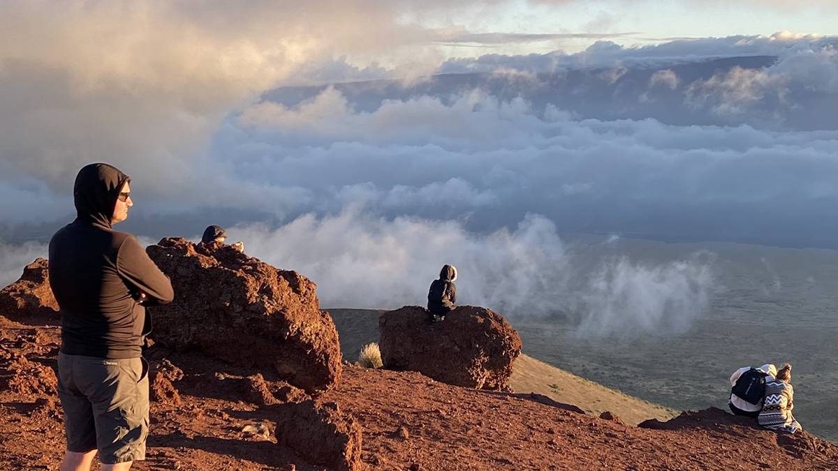 People hiking the Mauna Kea Visitors Center Volcano Hike in Hawaii, USA