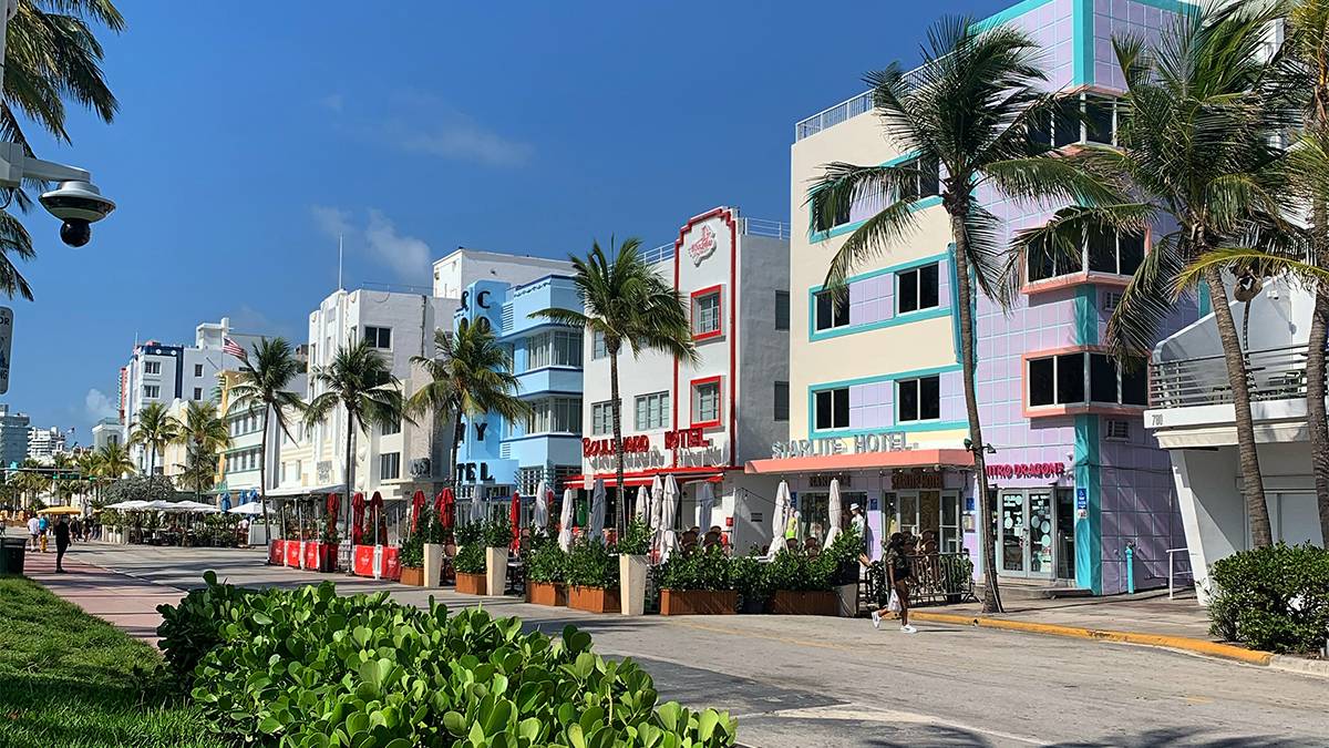 Ground view of Ocean Drive and all of the colorful vintage hotels on it on a sunny day in Miami, Florida, USA