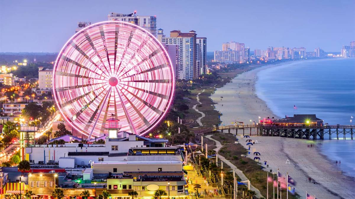 arial view of skywheel at night in lights along coastline in Myrtle Beach, South Carolina, USA