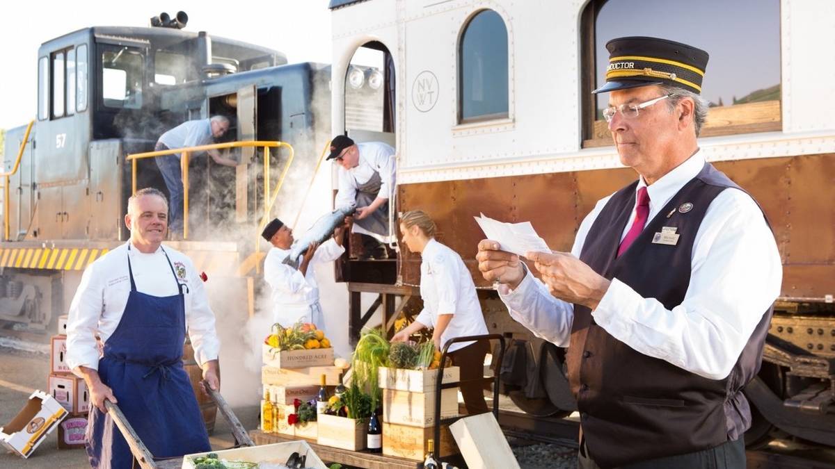 Several Napa Valley Wine crew members loading and checking fresh product onto the train